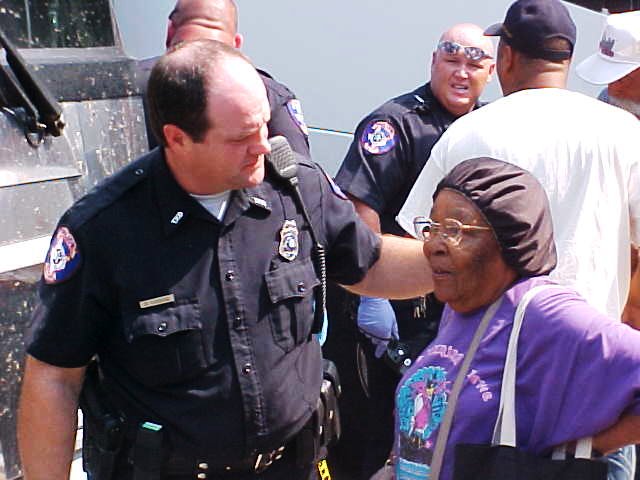 A police officer greets a civilian arriving to the shelter.